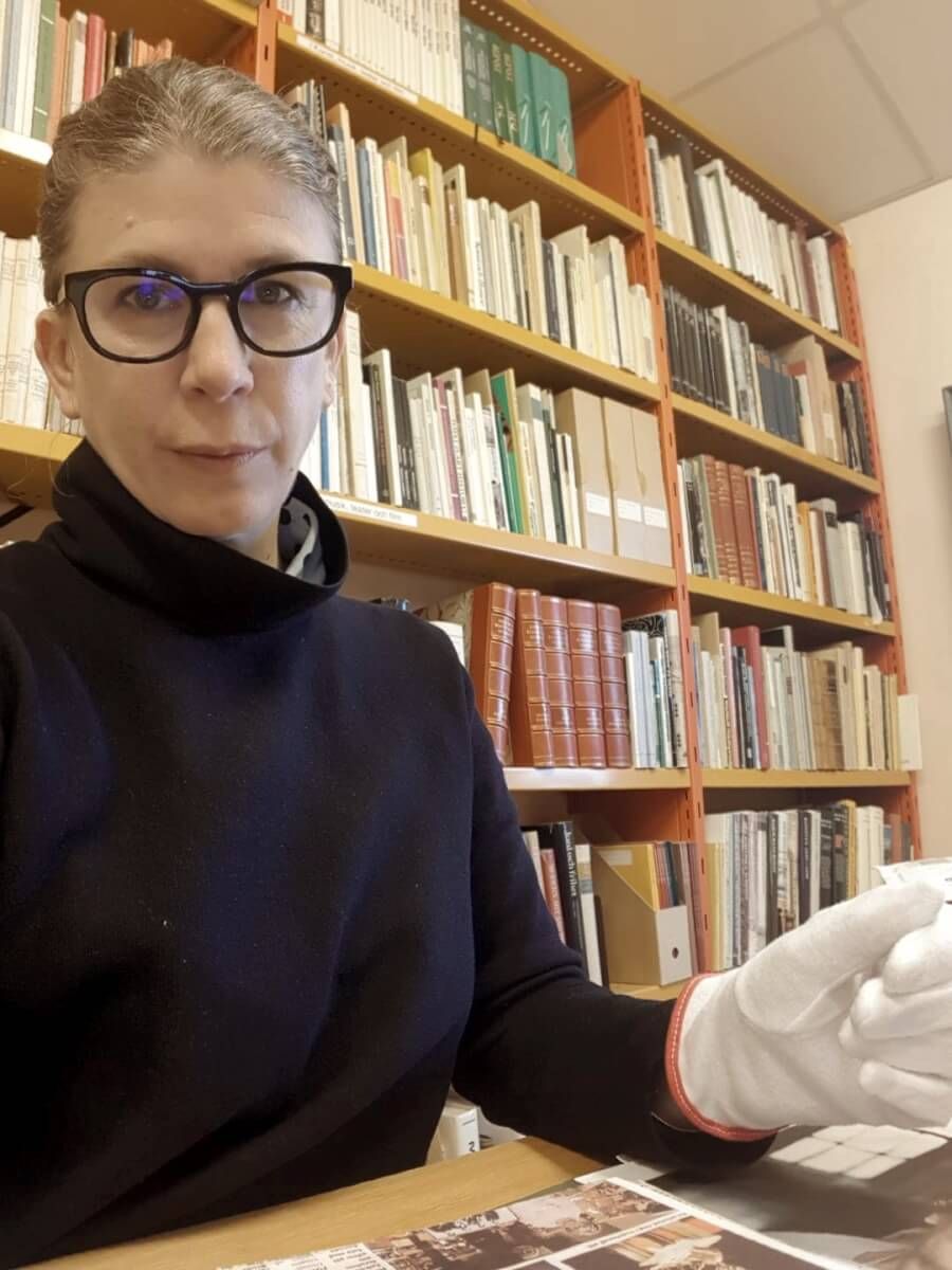 Christina Zetterlund sitter med arkivhandlingar ur Rosa Taikons arkiv i museets bibliotek