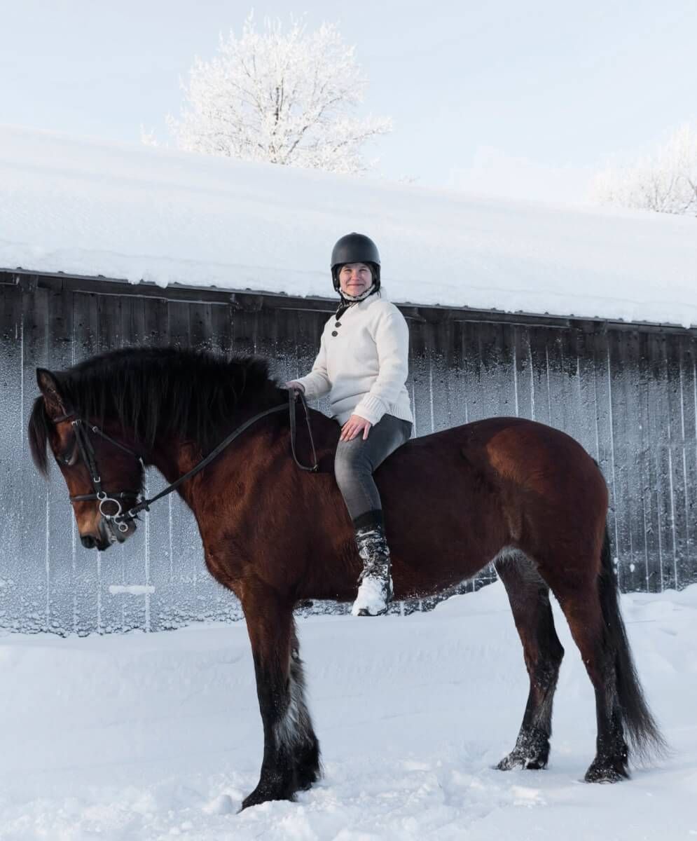 Vinterbild med kvinna på häst
